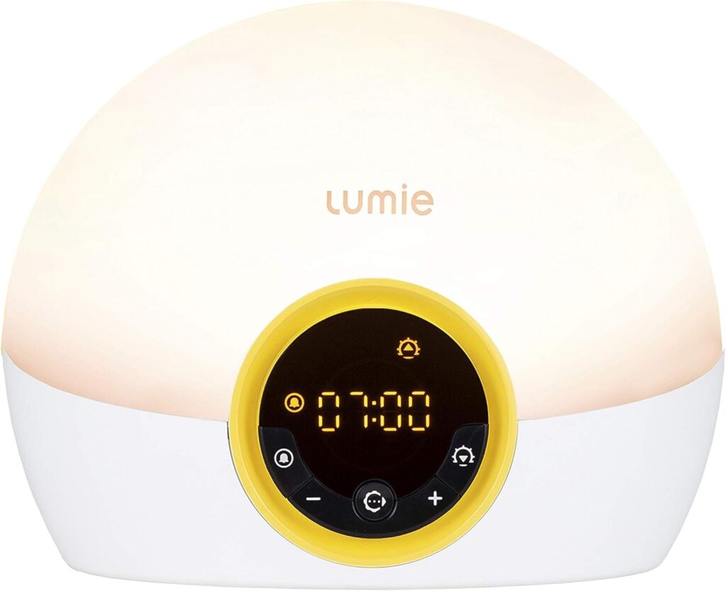 Vue de face du réveil Lumie, identique à l'image 0, mais avec un anneau jaune autour de l'écran et des boutons de contrôle.