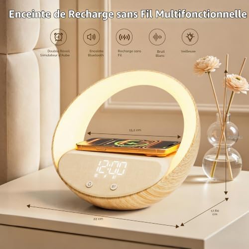Le radio-réveil posé sur une table de chevet, avec un smartphone en charge par induction. Dimensions du produit en surimpress...