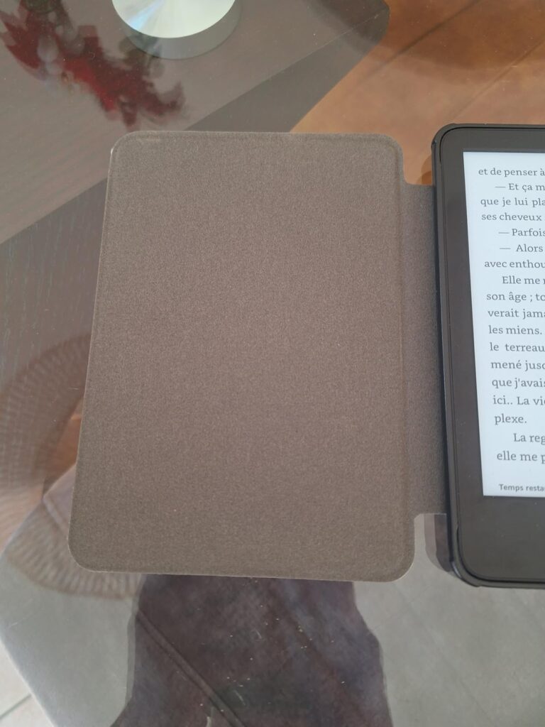 Liseuse Kindele Paperwhite dans son étui ouvert, sur un fond blanc. Le livre "Kindle Paperwhite User's Guide" est affiché à l...