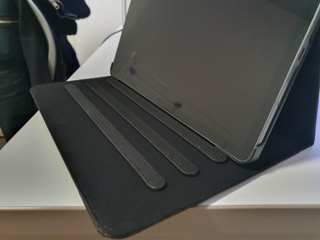 Gros plan sur l'intérieur d'une coque de tablette noire, montrant les encoches pour différentes inclinaisons.